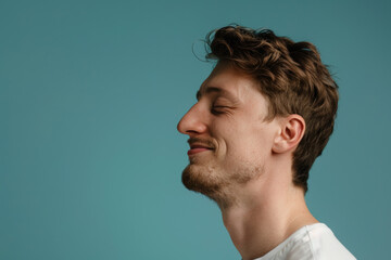 Obraz premium A close up of a man with beard and closed eyes looking to a side