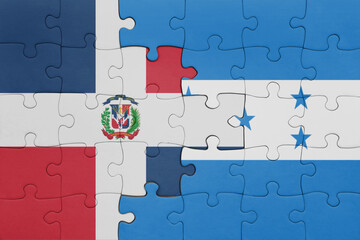 Fototapeta premium puzzle with the colourful national flag of honduras and flag of dominican republic .