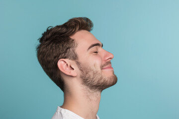 Obraz premium A close up of a man with beard and closed eyes looking to a side