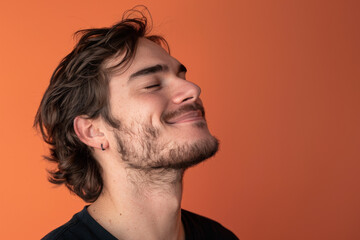 Fototapeta premium A close up of a man with beard and closed eyes looking to a side