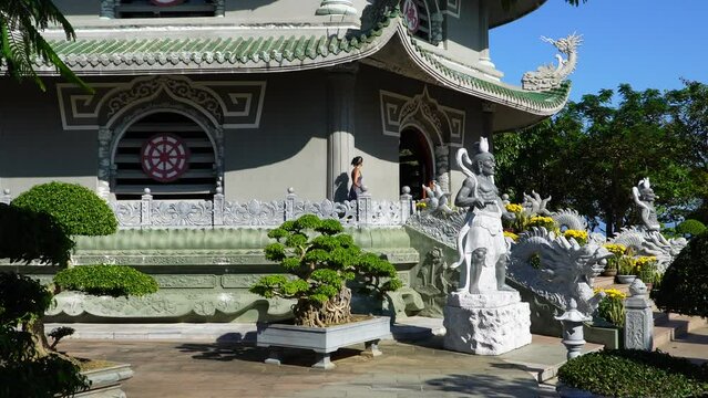 A beautiful girl walks along a Chinese pagoda