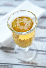 Glass of beer on bright wooden background. Copy space.