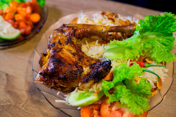 kabsa, rice, a typical Arabic dish, with grilled chicken and fresh vegetables