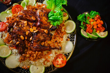 kabsa, rice, a typical Arabic dish, with grilled chicken and fresh vegetables