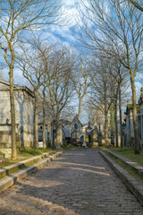 Paris, the Pere-Lachaise cemetery, cobbled alley with graves 
