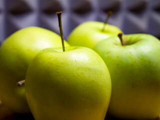 Bright green apples, wooden table, wellness concept.