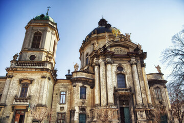 Fototapeta premium Sunlit Devotion: Facade of an ancient church with artistic stonework, representing worship. The Dominican church and monastery