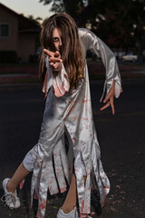 One Girl Halloween Costume, Bloody Zombie, Reaching Hand Forward, Outside, California, USA, Vertical