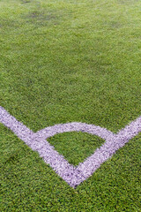 white lines on the synthetic grass football pitch drawing a corner kick