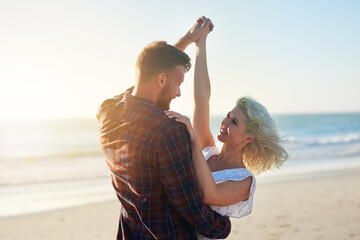 Love, smile and couple dance at beach on holiday, travel or summer vacation outdoor in nature. Romance, man and woman holding hands at sea together for connection, support and celebration at ocean