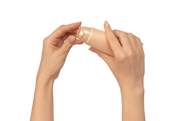 Beige cream tube in woman hands isolated on a white background. Cream swatch on woman hand.