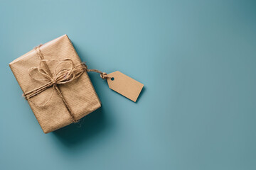 A neatly wrapped gift box with a blank tag floats serenely against an ethereal clean blue background, evoking a sense of celebration and anticipation for World Father's Day.
