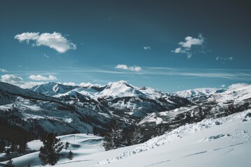 Fototapeta premium Majestic Snow-Covered Mountain Range with Space for Text in Sky