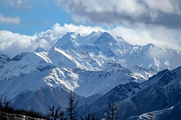 Fototapeta premium Serene Winter Landscape: Snow-Covered Mountain Range with Copy Space in Sky