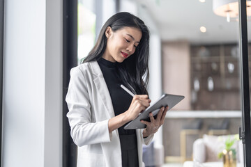 Beautiful asian doctor Education profession doctor in white uniform gown coat Professional medical doctor with tablet at seminar or hospital wellness center