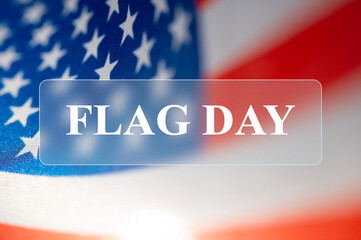 Happy Flag Day blurred greeting background and text in the frame. American flag with glassmorphism...