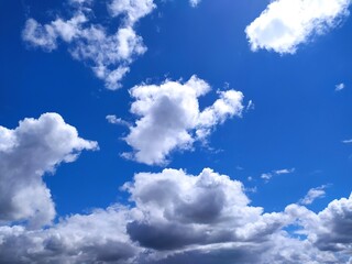 Clear blue sky texture and white fluffy cloud nature background. The sun shines bright in the daytime in summer