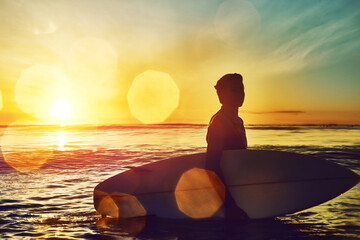 Sunset, man or surfer at sea for fitness training, workout or sports exercise in ocean, nature or...
