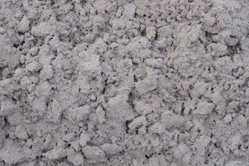 gray dry sand texture in a heap in the street
