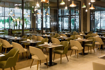 Spacious empty restaurant hall first rays of the summer sun.
