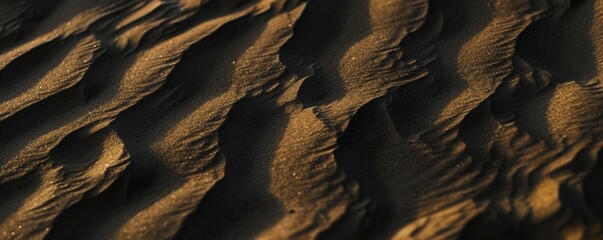 Desert sand. Close-up view of desert sand with subtle black hues color, showing delicate ripples...