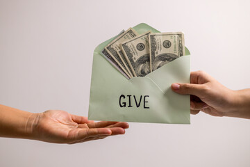 Carefully budgeting her money, she placed cash into separate envelopes for giving, business...