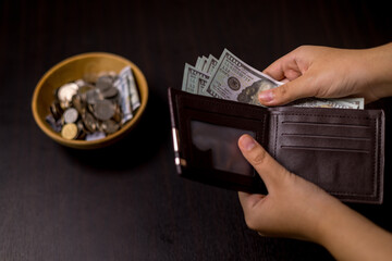 She felt deep sense of fulfillment when donating money to church, placing her tithe of coins and cash into offering bowl, knowing her giving would help fund important causes. donating, money, tithe.