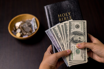 She felt deep sense of fulfillment when donating money to church, placing her tithe of coins and...