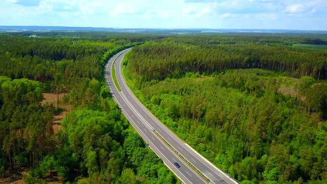 Aerial view of a highway going through the forest. D5 highway in Czech republic, European union. Beautiful forest with highway from drone view.