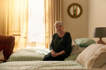 Elderly woman, portrait and sitting in bedroom with smile for retirement, wellness and confidence...