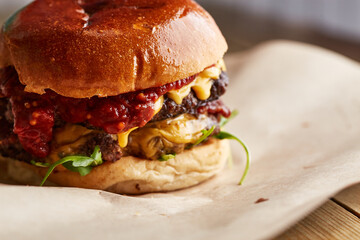 Double cheeseburger with tomato relish in a brioche bun