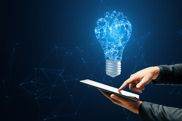 A digital light bulb with a brain pattern above a tablet, symbolizing innovation on a dark blue network background