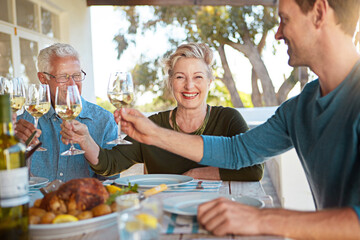 Cheers, wine and happy family in backyard lunch celebration, eating and bonding together at table. Smile, men and women toast with glass, drinks and food at patio dinner for holiday, fun or relax