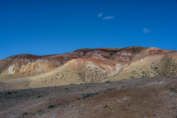 panoramic landscape with unusual red mountains with a Martian view filmed from a drone in Altai in May