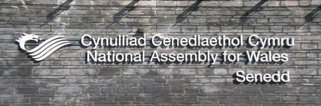 The sign at the building of the National Assembly for Wales / Cynulliad Cenedlaethol Cymru in Cardiff Bay, Cardiff, Wales, UK.