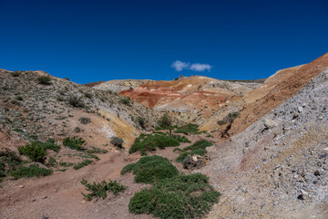 panoramic landscape with unusual red mountains with a Martian view filmed from a drone in Altai in May