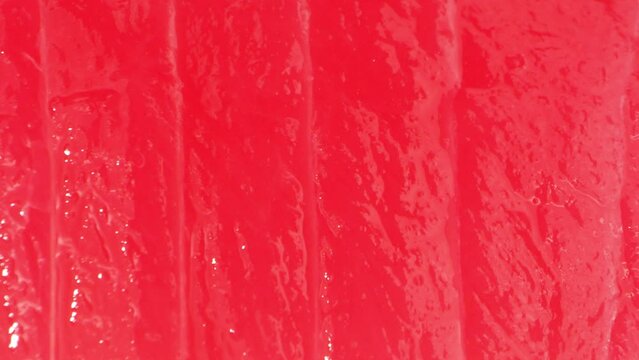 A close-up reveals a vibrant red hue and velvety texture of the sliced tuna. Even marbling and a glossy finish underscore its premium quality, symbolizing freshness and excellence.
