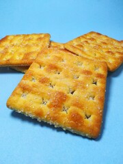 four brown gabing biscuits on a blue background