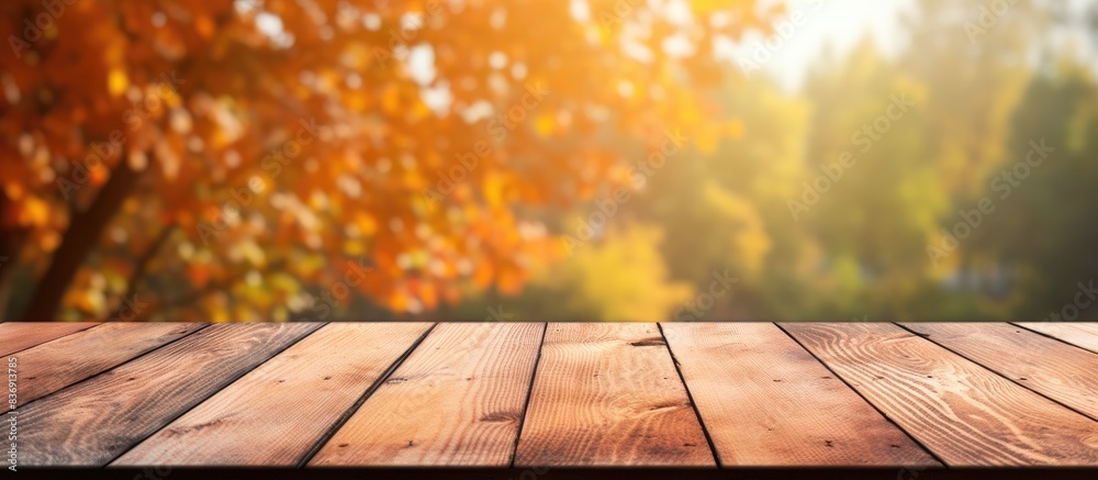 Aufkleber Wooden table with autumn nature park background perfect for displaying products with copy space image.