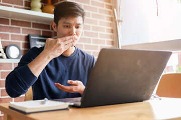 Fototapeta premium close up asian employee make gesture hand about help sign language to meeting and talking with team from webinar in home for office culture lifestyle concept