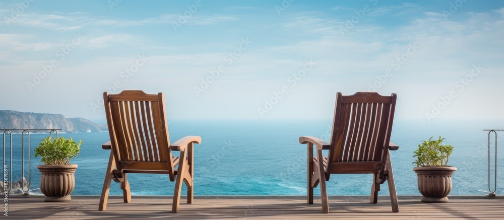 Aufkleber A lovely set of chairs sit on the balcony overlooking the ocean, creating a tranquil spot with a serene view of the sea and copy space image.