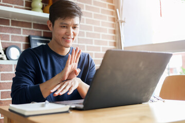 close up asian employee make gesture hand about help sign language to meeting and talking with team from webinar in home for office culture lifestyle concept