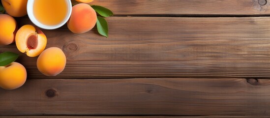 Apricots and apricot juice arranged in a flat lay composition on a wooden background, with a designated copy space image.