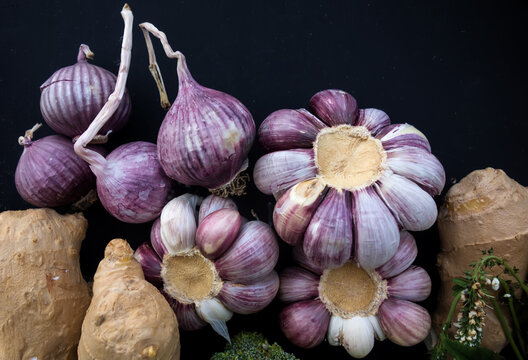 Still life of fresh vegetables. Purple garlic and ginger close-up