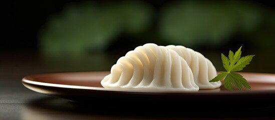 Japanese sweet, Warabimochi, is a bracken-starch dumpling with a delicious taste and a unique appearance, often displayed in a traditional setting surrounded by copy space image.