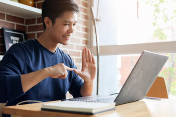 close up asian employee make gesture hand about help sign language to meeting and talking with team from webinar in home for office culture lifestyle concept
