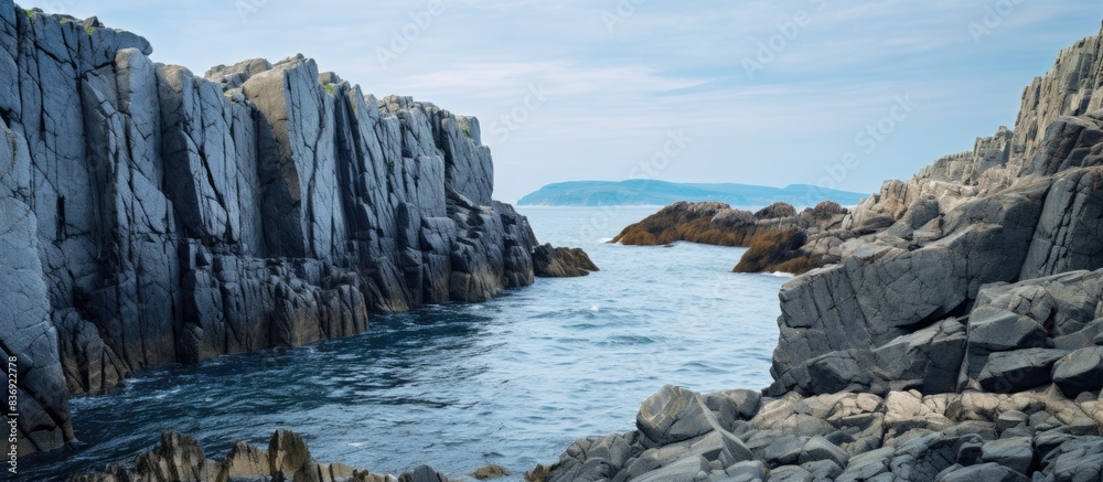 Poster The rocks along the coastline create a scenic backdrop with copy space image.