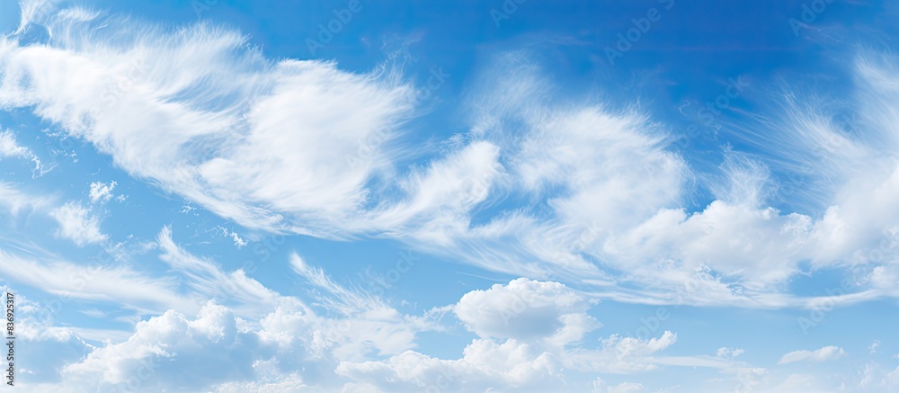 Poster background of a blue sky during the day with cirrus clouds, perfect for copy space image.
