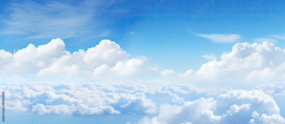 Poster Scenic view of a clear blue sky featuring fluffy white clouds, ideal for using as a copy space image.