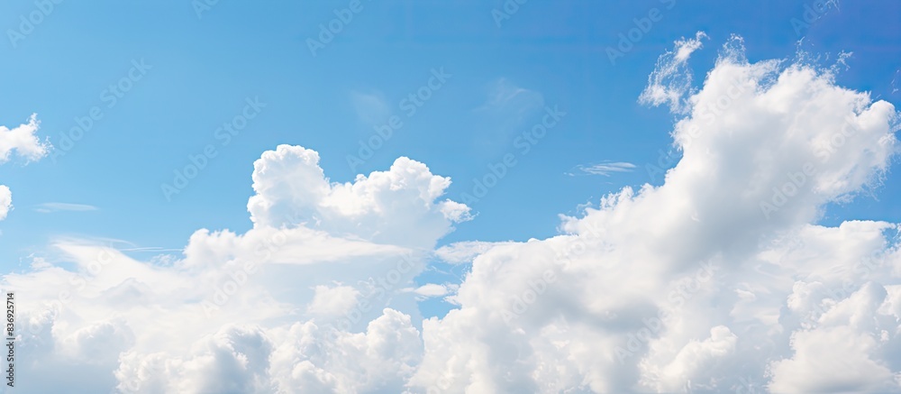 Poster Summer sky with fluffy clouds in shades of orange and blue, ideal for displaying copy space image.